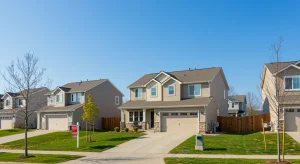 Modern suburban neighborhood with 'Sold' sign, reflecting 2026 housing market growth