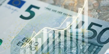 Billete de 5 euros español con gráfico financiero ascendente, simbolizando la inversión en deuda pública.