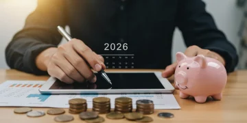 Financial planning for 2026 with a tablet and savings symbols