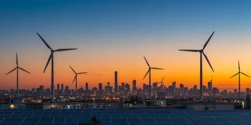 Futuristic city with wind turbines and solar panels powered by clean energy for 2026