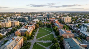 The Data-Driven Nexus: Unpacking Interdependencies in Education Funding, Local Jobs, Personal Finance, and Small Business Aerial view of a vibrant university campus nestled within a bustling city at sunset, symbolizing education funding as an investment in human capital.