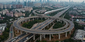 Modern highway and high-speed rail network with urban landscape