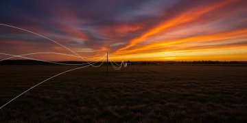 Fiber optic cables spanning a rural landscape at sunset, representing the 2026 federal broadband expansion.